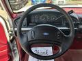 Steering wheel of a 1995 Ford F-250 with a Ford emblem and control buttons visible