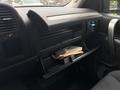A 2013 Chevrolet Silverado 3500HD with an open glove compartment containing several books and documents