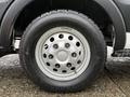 Close-up of a round silver wheel with a black tire labeled Hunterforce CV showing tread patterns and bolts around the rim