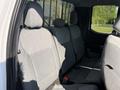 The image shows the back seats of a 2021 Ford F-150 with gray fabric upholstery and seatbelts visible