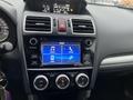 Interior dashboard of a 2016 Subaru Forester featuring a touchscreen display with audio and phone options along with climate control buttons and an instrument cluster behind the steering wheel