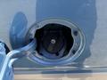 Close-up of the fuel filler cap and nozzle for a 2008 Ford E-350