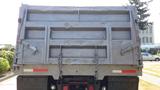A grey 2003 International 5600i truck viewed from the rear with a dump bed and chains securing the sides