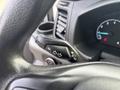 A close-up view of the steering column controls of a 2021 Ford Transit-350 including turn signal and headlight toggle switches