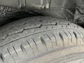 Close-up of a worn tire from a 2009 Toyota Hiace showing visible tread patterns and signs of use