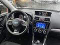 Interior view of a 2016 Subaru Forester showing the steering wheel dashboard and infotainment display