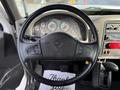 Steering wheel of a 2010 International 4300 with controls and gauges visible on the dashboard