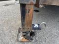 Close-up of a rusty hydraulic stabilizer leg from a 2013 JLG Industries 1014 with a metallic foot and a locking mechanism