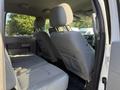 Interior of a 2014 Ford F-550 showing the rear bench seat and headrests in gray fabric