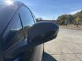 A 2023 Fisker Ocean with a sleek design and a prominent side mirror seen in profile
