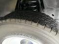 Close-up of a worn tire on a 2012 Ford Econoline displaying tread patterns and the wheel rim without any other components visible