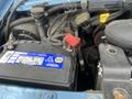 A 2006 Ford Econoline engine compartment showing the battery with labels and connections, along with visible hoses and components