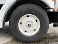 Close-up of a large tire mounted on a white 2006 Sterling L7500 truck featuring a solid wheel with multi-bolt pattern and visible tread details