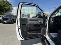 A 2020 Ram 2500 truck with an open driver's side door showcasing the interior door panel and controls