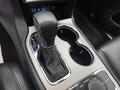 The image shows the gear shift of a 2019 Jeep Grand Cherokee with a leather boot and surrounding console controls