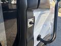 Close-up of a 2017 Ford Transit-350 door handle mechanism with a metal plate and a black handle attached