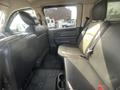 Interior of a 2012 RAM 2500 showing the backseat with black leather upholstery and floor mats