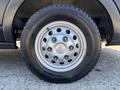 Close-up of a silver wheel with a five-spoke design mounted on a Continental tire labeled VanContact A1
