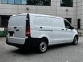 A white 2020 Mercedes-Benz Metris van viewed from the rear with a sliding side door and circular wheels
