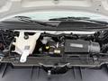 Engine compartment of a 2013 Chevrolet Express showcasing the engine components including the air intake system and coolant reservoir