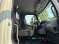 Interior view of a 2016 Freightliner M2 106 showing the driver's seat steering wheel and dashboard