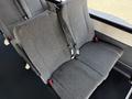 Interior seating of a 2021 Ford Econoline showing gray fabric upholstery with seatbelts