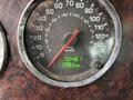 Speedometer of a 2013 Kenworth T370 showing 70.461 mph and 296.9 km on a circular gauge with a black background and silver rim