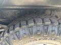 Close-up of the tread on a heavy-duty tire from a 1995 Ford F-250 showcasing its rugged design and deep grooves for traction
