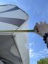 A person measuring the edge of a 2018 Westland Travelaire with a tape measure