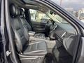 Interior of a 2015 Dodge Durango showcasing black leather front seats and a center console with controls and cup holders