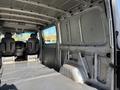 A 2007 Dodge Sprinter van interior showing two front seats and a spacious empty cargo area with a textured floor and metal walls
