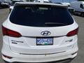 A white 2018 Hyundai Santa Fe with a rear-view design featuring the model name and a license plate reading MS9 42B