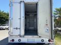 A 2019 Freightliner MT45 with an open rear door revealing a spacious cargo area with a clean metal floor and interior lighting