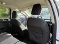 Interior view of a 2020 Ford Escape showing black cloth seats and headrests of the front seats with the dashboard visible in the distance