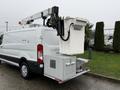 A 2019 Ford Transit van with a Versalift bucket lift attached to the roof and a tool storage compartment on the rear