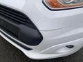 A 2017 Ford Transit Connect with a damaged front bumper and visible scratches near the headlight