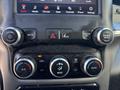 Dashboard controls of a 2021 RAM 5500 featuring climate control knobs buttons for media and app settings and a touchscreen display