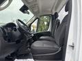 Interior view of a 2023 RAM Promaster 3500 showing the driver's seat and passenger seat with grey fabric upholstery and a modern dashboard design