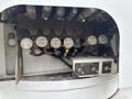 A close-up of a control panel featuring various valves and switches labeled for different functions including boom rotate winch and pole guide on a 2013 Freightliner 114SD