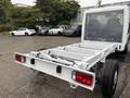 A 2023 RAM Promaster 3500 chassis viewed from the rear with an open cargo area and red taillights on a white truck body