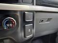 Dashboard controls of a 2021 Ford F-150 featuring a climate control knob and two buttons for power and auxiliary connections