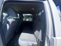 Interior view of a 2016 Ford F-350 SD showing the backseat area with gray fabric seats and headrests