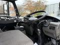 The interior cabin of a 2009 UD Trucks UD 3300 featuring a steering wheel dashboard and gear shift with visible keys in the ignition