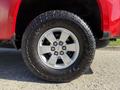 A close-up view of a silver alloy wheel and tire of a 2018 GMC Canyon showcasing the Goodyear Wrangler tire tread pattern