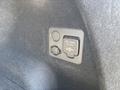 A power outlet panel featuring a 120V AC outlet and a safety cap in the interior of a 2023 Fisker Ocean