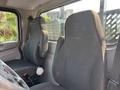 Interior view of a 2020 Peterbilt 330 featuring two black upholstered seats with headrests designed for driver and passenger comfort