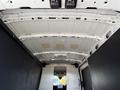 Interior view of a 2022 Ford Transit showing the roof and cargo area with a white ceiling and dark walls