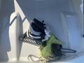 A collection of ropes and a ladder resting on a green cloth inside a boat compartment