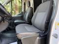 Interior view of a 2022 Ford Transit showing two gray upholstered front seats designed for comfort and utility