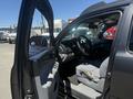 Interior view of a 2010 Toyota Tacoma showing the driver's seat steering wheel and control panel